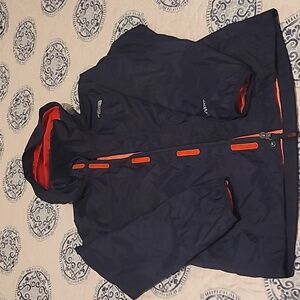 The North Face kids navy with red trim raincoat. Medium.